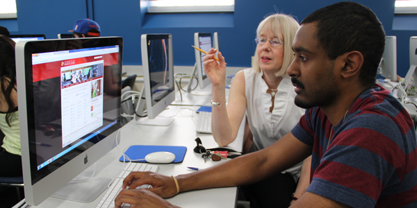 Librarian with student at computer